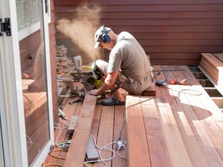 Trex Decking Installation, Simi Valley A team of skilled contractors carefully installing Trex composite decking boards on a wooden frame